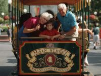 Guests injoy a ride on one of the many Main Street vehicles inside Magic Kingdom.